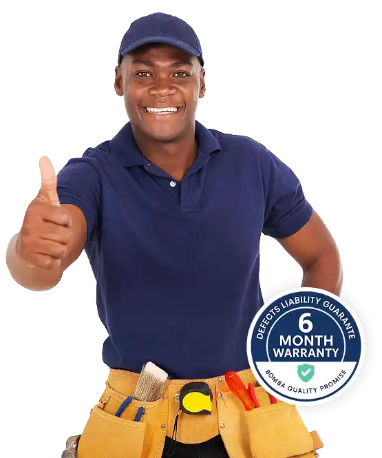 Smiling plumber with a tool belt giving a thumbs-up alongside a six-month warranty badge – Bomba Plumbers guarantee of quality.