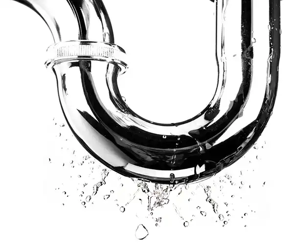 Chrome U-bend pipe with water droplets illustrating plumbing drainage and potential leaks.