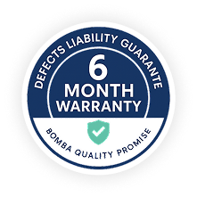 Round blue badge stating “Defects Liability Guarantee – 6 Month Warranty,” certifying Bomba Plumbers workmanship.